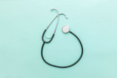 High angle view of stethoscope on blue background