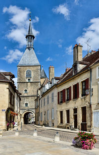 Street amidst buildings against sky