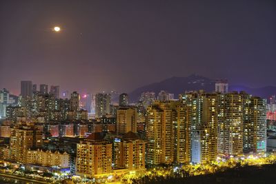 Aerial view of city lit up at night