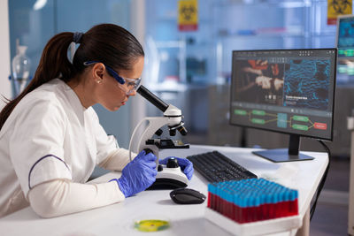 Side view of young woman working in office