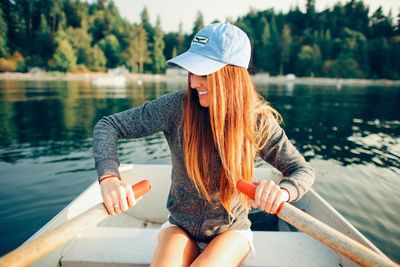 Rear view of woman sitting in river
