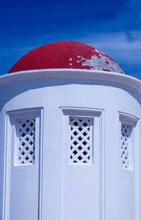 Close-up of red building against blue sky