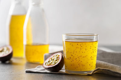 Passion fruit drink with chia seeds in a glass glass.