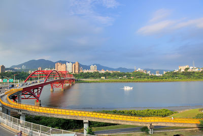 Bridge over river against buildings in city