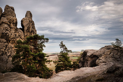 Rock formations on landscape against sky