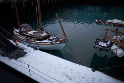 High angle view of boats moored in lake during winter