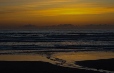 Scenic view of sea against orange sky