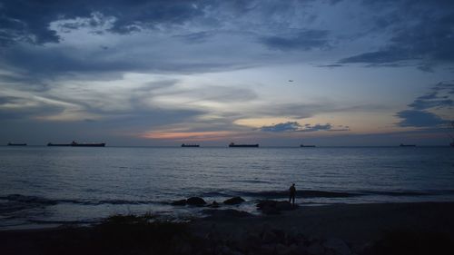 Scenic view of sea against sky at sunset