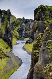 Scenic view of waterfall against sky