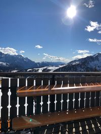 Scenic view of snowcapped mountains against bright sun