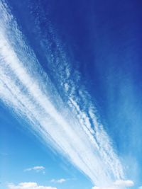 Low angle view of vapor trail in blue sky