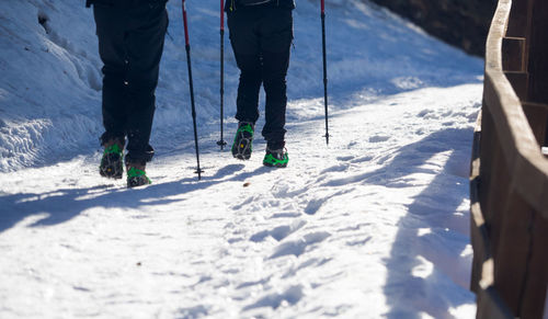 Low section of person skiing on snow covered mountain