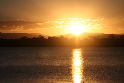 Scenic shot of calm countryside lake at sunset