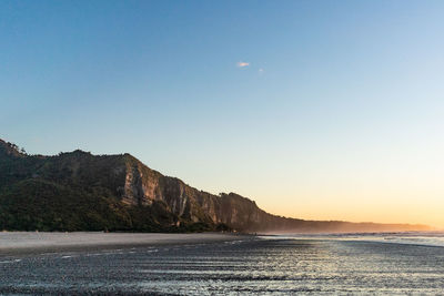 Scenic view of sea against clear sky during sunset