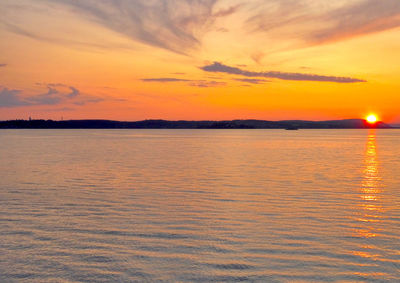 Scenic view of sea against romantic sky at sunset