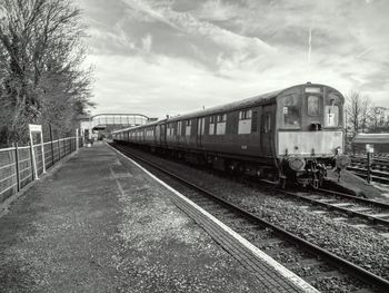 Train on railroad tracks against sky