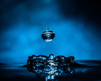Close-up of water drop against blue background