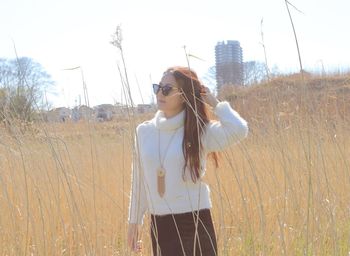 Young woman looking away on field