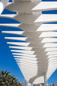 Low angle view of modern building against clear blue sky