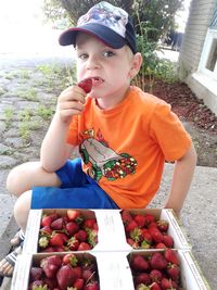 Portrait of boy holding fruits