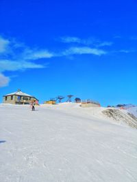 Built structure on beach against blue sky