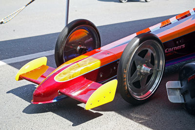 Close-up of multi colored vehicles on road