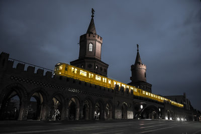 Low angle view of illuminated building against sky at night