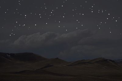 Scenic view of mountains against sky at night