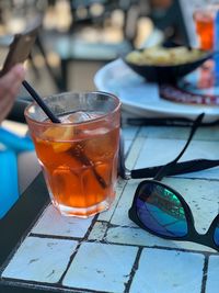 High angle view of drink and sunglasses on table