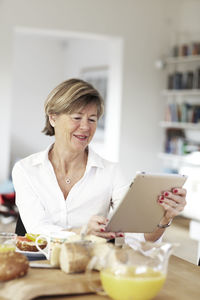 Mature woman using digital tablet