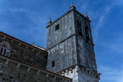 Low angle view of bell tower against sky