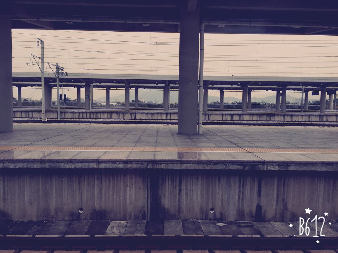 transportation, railroad station, railroad station platform, built structure, architecture, public transportation, railroad track, rail transportation, mode of transport, train - vehicle, indoors, architectural column, travel, train, empty, sky, public transport, incidental people, passenger train, no people