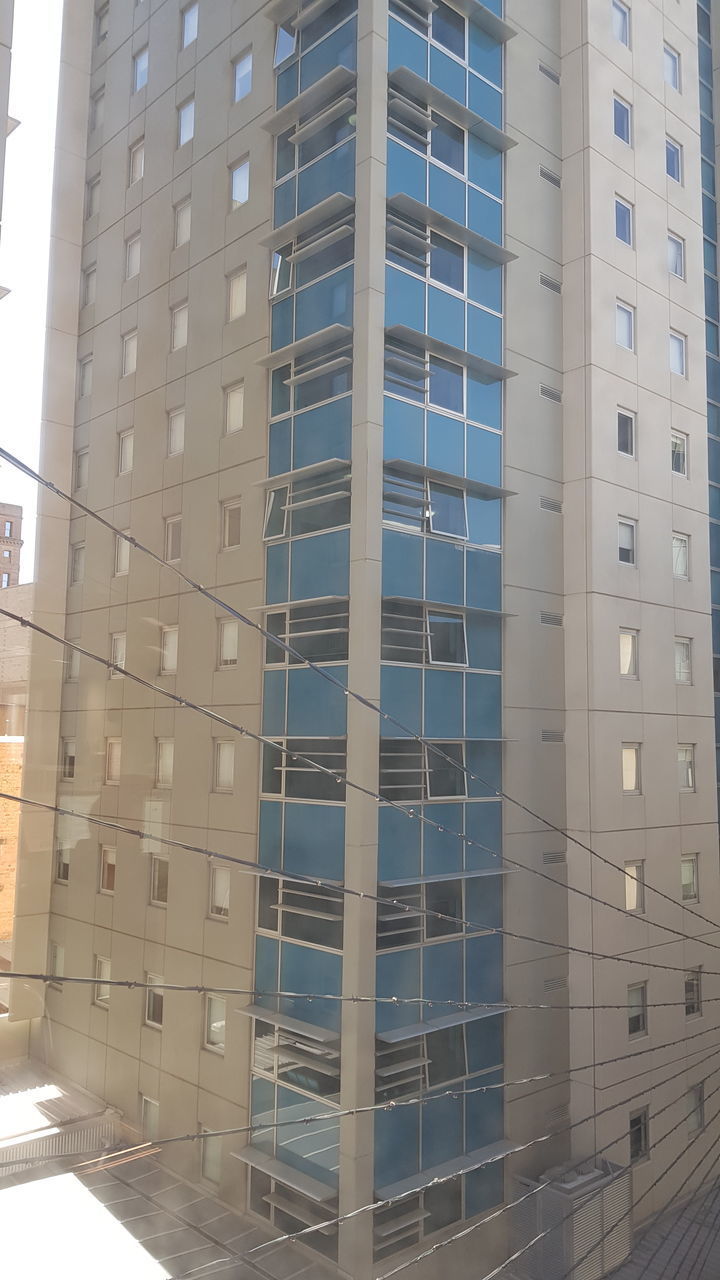 LOW ANGLE VIEW OF MODERN BUILDINGS AGAINST SKY