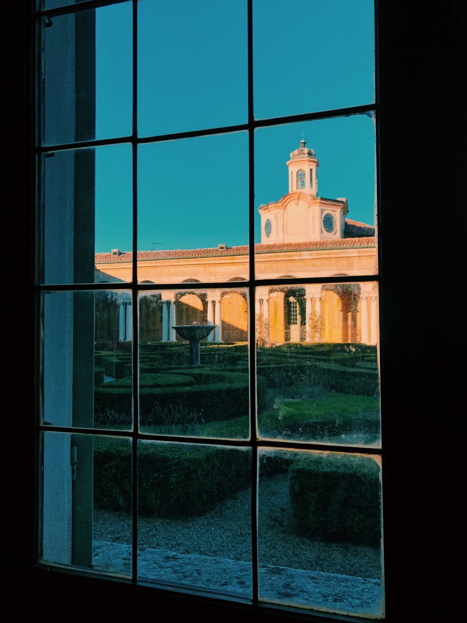 REFLECTION OF BUILDINGS IN GLASS WINDOW