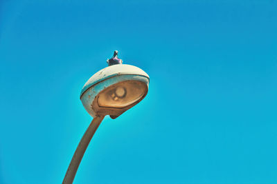 Low angle view of street light against clear blue sky