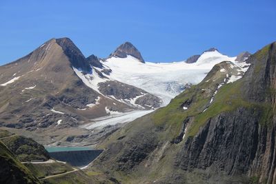 Scenic view of snowcapped mountains against clear blue sky