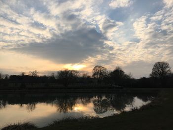 Scenic view of lake against sky during sunset