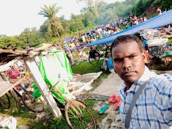 Portrait of young man against plants