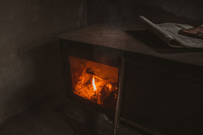 High angle view of burning candles on wood