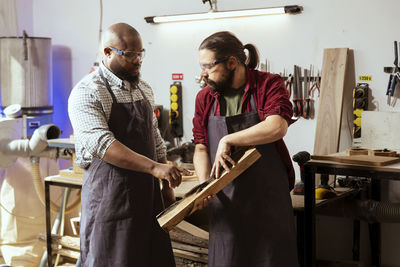 Side view of man working in workshop