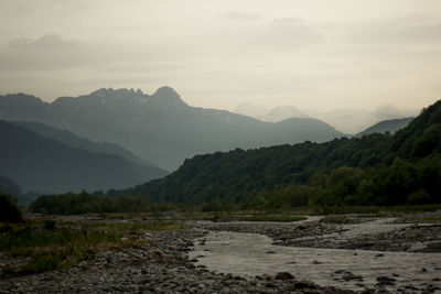 Scenic view of lake and mountains against sky