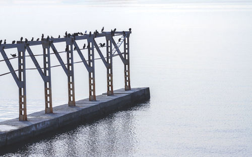 Pier over sea against sky