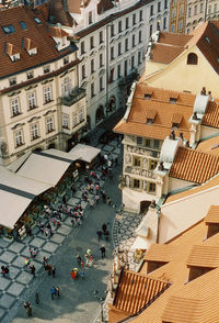 High angle view of people walking on street amidst buildings in city