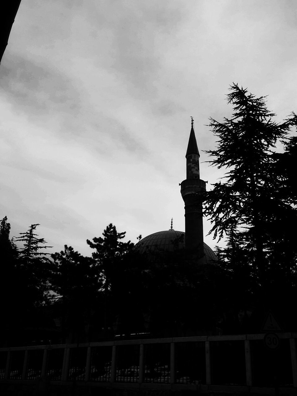 architecture, built structure, sky, tree, building exterior, low angle view, cloud - sky, religion, spirituality, place of worship, silhouette, tower, cloud, history, cloudy, cross, outdoors, church, no people