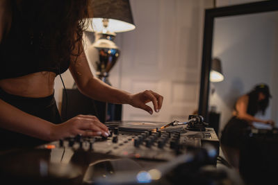 Fashionable young woman playing music at home