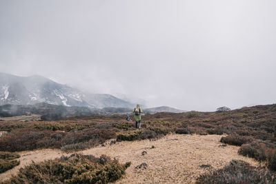 Rear view of man walking on land