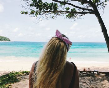 Rear view of woman looking at sea against sky