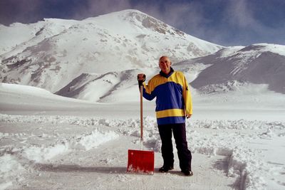 Full length of man standing on snowcapped mountain