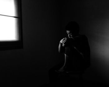 Man sitting on wall at home