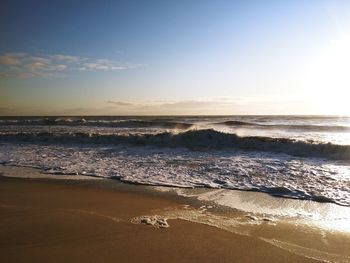 Scenic view of beach against sky during sunset